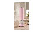 Pink electric salt grinder with sea salt on a wooden kitchen counter.