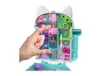 Polly Pocket compact playset shaped like a cat's head, with a hand interacting with a doll and elevator.