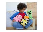 A smiling child holding a pink pig, orange fox, yellow bee, and green creeper plush toys.
