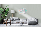Multi-photo white frame with "Live Laugh Love" decor, gray sofa and plant.