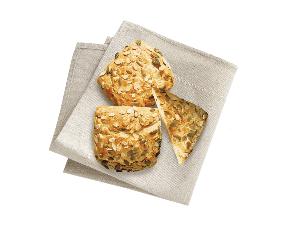 Zwei Kürbiskernbrötchen und ein halbiertes Brötchen auf einem Leinentuch.