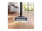 Cordless vacuum cleaner head with LED light cleaning dust and hair on a wooden floor