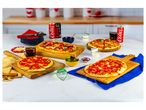 Four small pizzas on wooden boards, with Coca-Cola cans and other food items.