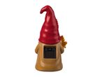 Back view of a garden gnome with a red hat, holding a leaf, and a solar panel on its back.