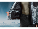 Crivit ski jacket with a gray and black print, with a black interior, worn by a person.