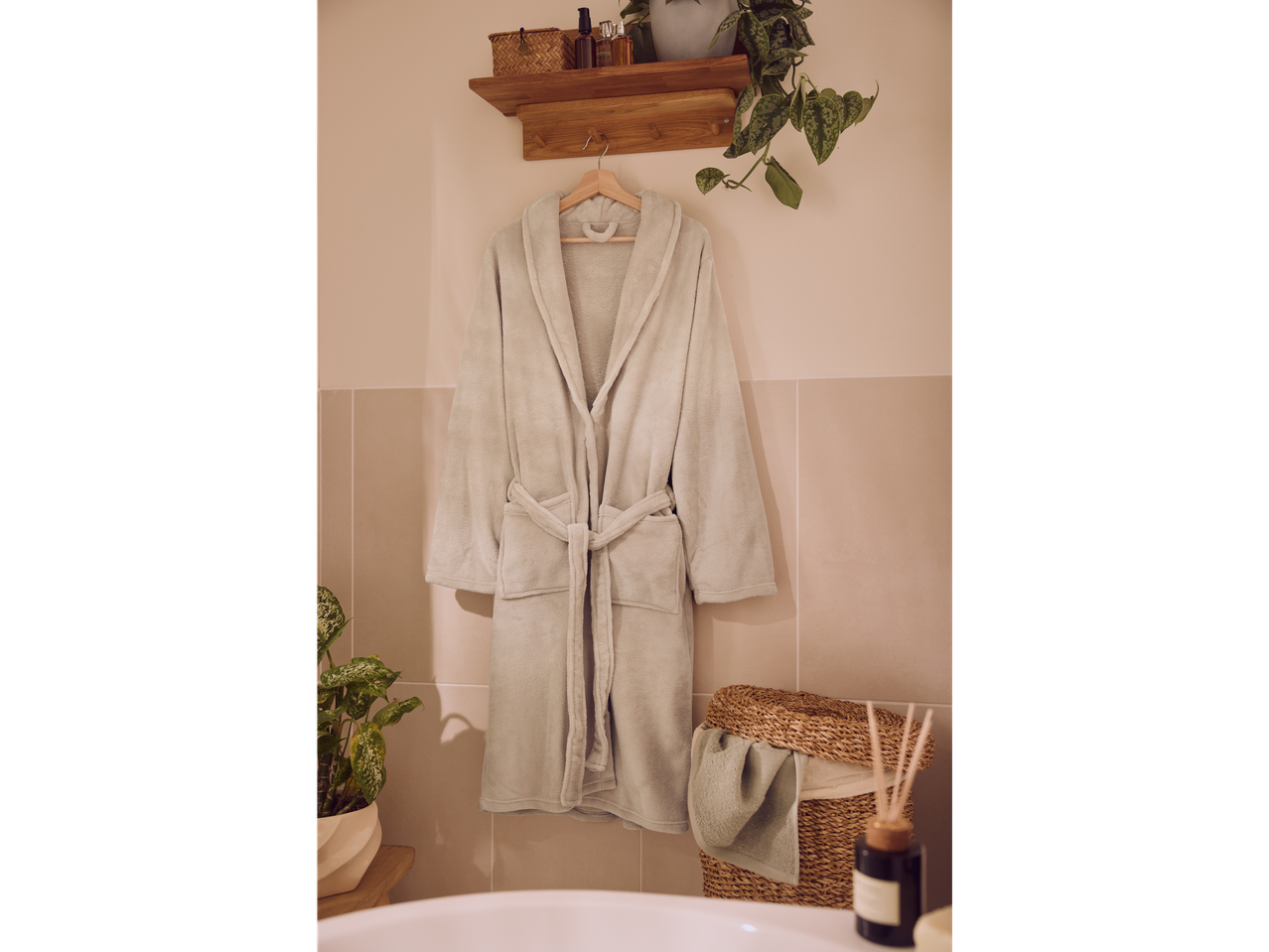 LIVARNO badjas hangend in een badkamer met planten en mand.