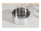 Stainless steel cooking pot with measurement markings on a white marble surface.