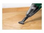 Handheld wet and dry vacuum cleaner cleaning a spill on a wooden floor.