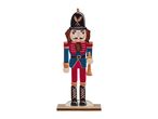 Wooden nutcracker decoration in a soldier's uniform, holding a horn.