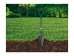 A Parkside digging spade is partially inserted into the ground, showcasing its design and functionality.