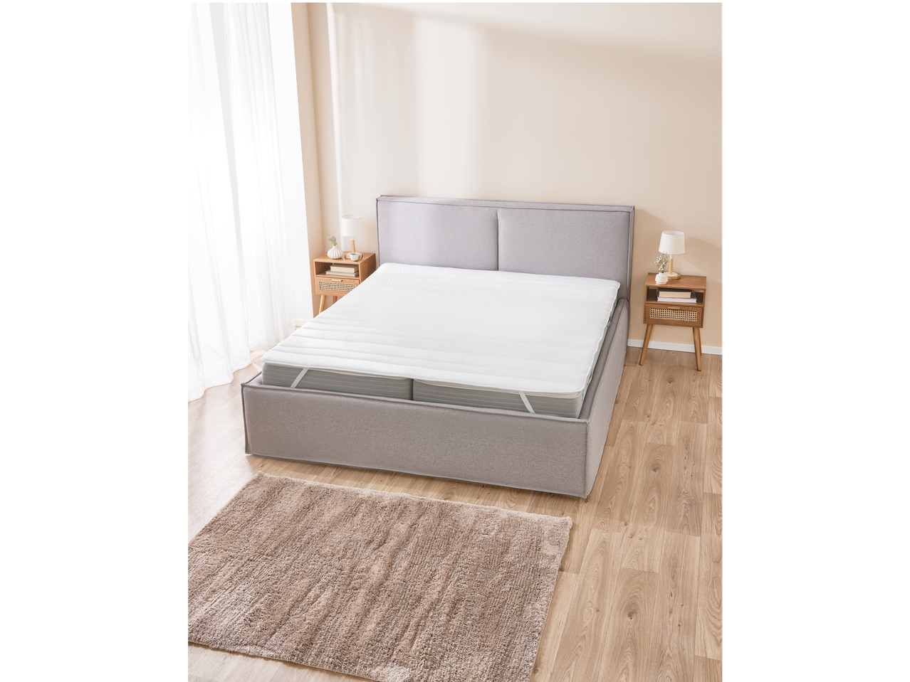 Mattress protector and bed with bedding in a modern bedroom.