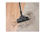 A vacuum cleaner head cleaning dirt from a wooden floor and a carpet.