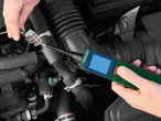 Hands using a Parkside automotive diagnostic tool to test a car's electrical connector.