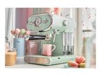 A mint green SilverCrest espresso machine brewing coffee into a pink mug.