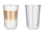 Two double-walled glasses, one with a layered latte macchiato and the other empty.