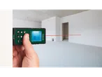 Parkside laser distance measurer in use, measuring an empty room.