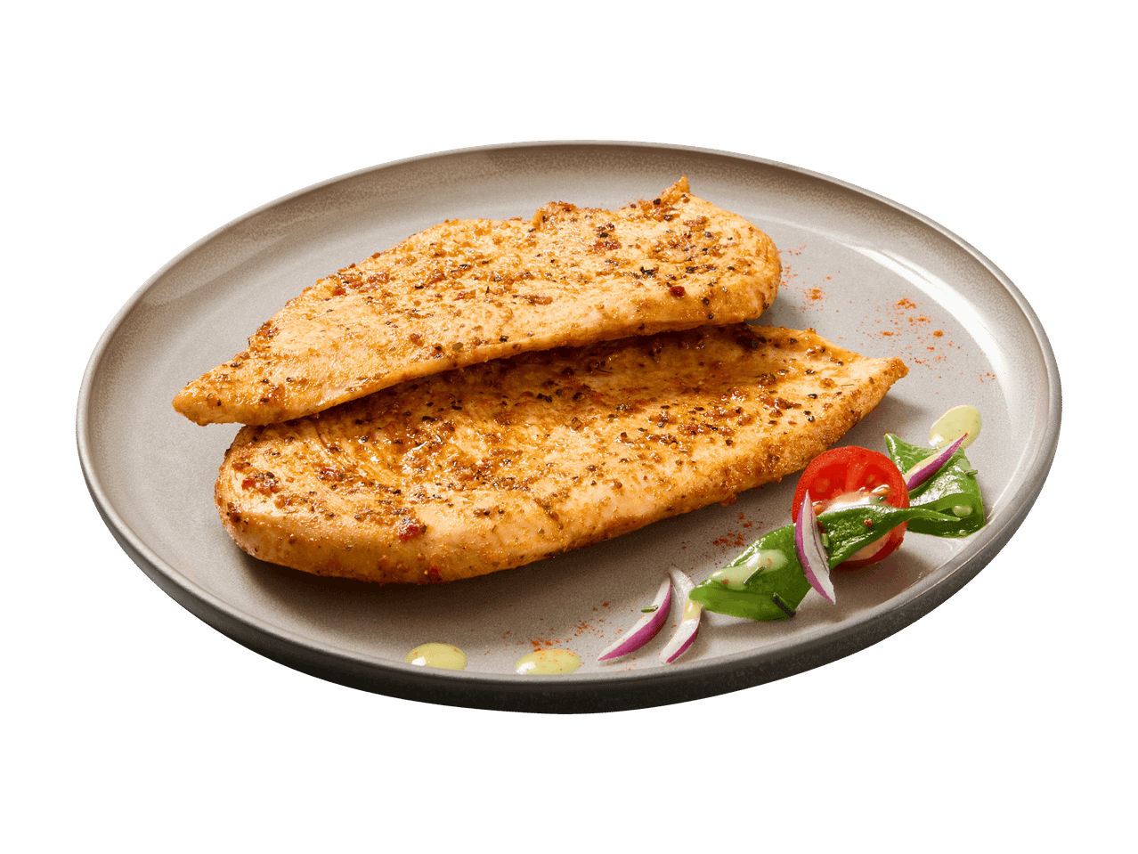 Zwei gewürzte Hähnchenbrustfilets mit Beilagensalat auf einem Teller.