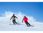 Two skiers wear Crivit ski jackets on a snowy slope.
