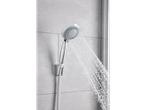 Chrome shower head with water stream.