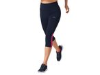 Woman wearing navy blue cropped leggings with pink side panels and dark athletic shoes.