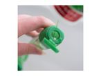 Close-up of a hand holding a green bottle, pouring liquid from its spout.