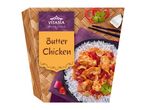 Butter Chicken with rice, red peppers, and cilantro, on a woven mat.