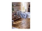 Clothes drying rack with laundry in a bright room with wooden shelves and a window.
