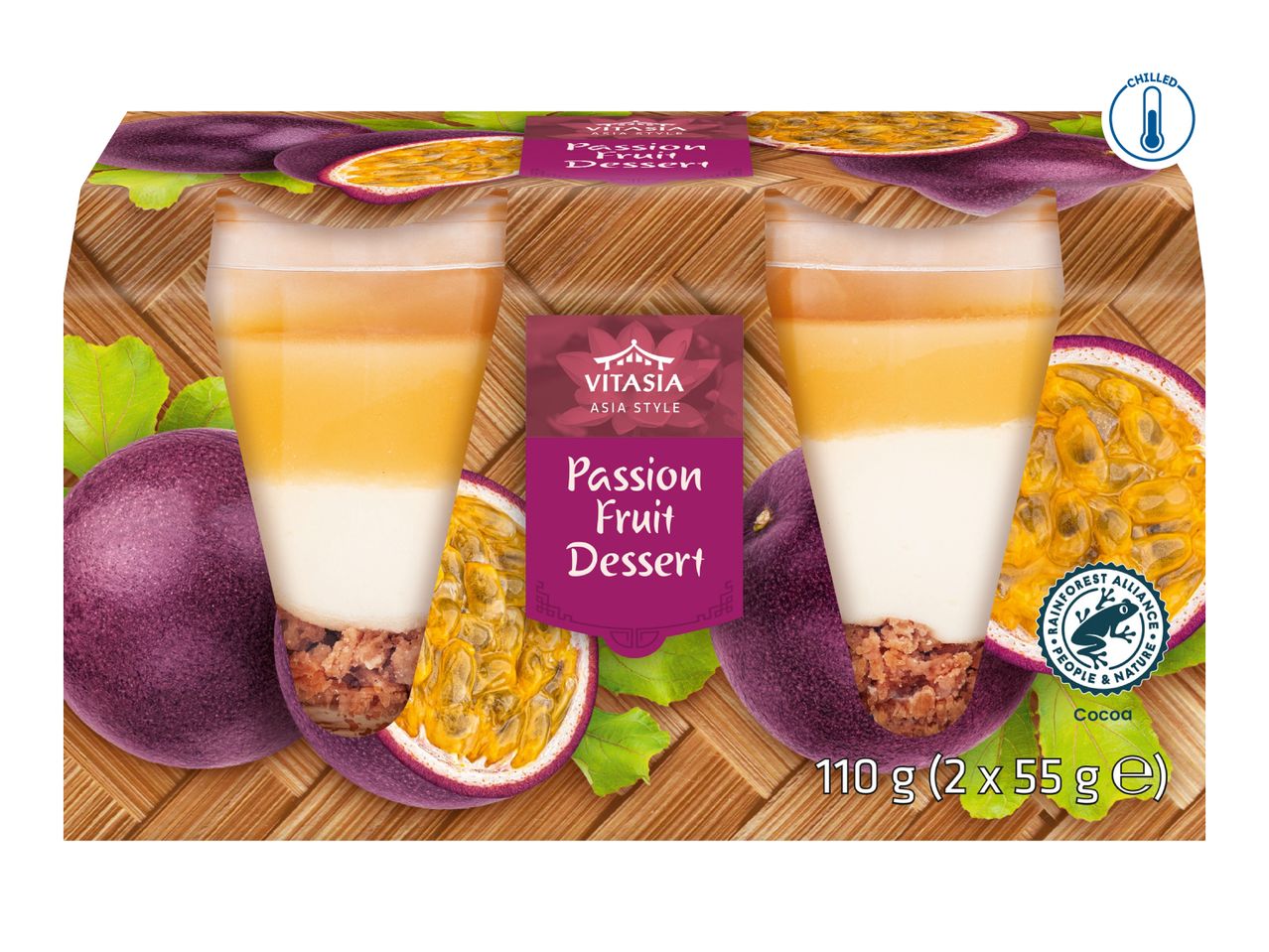 Two passion fruit desserts with a layered appearance, on a bamboo mat background with whole and halved passion fruits.