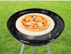 Piatră de pizza GRILLMEISTER cu pizza pe grătar, pe iarbă verde.