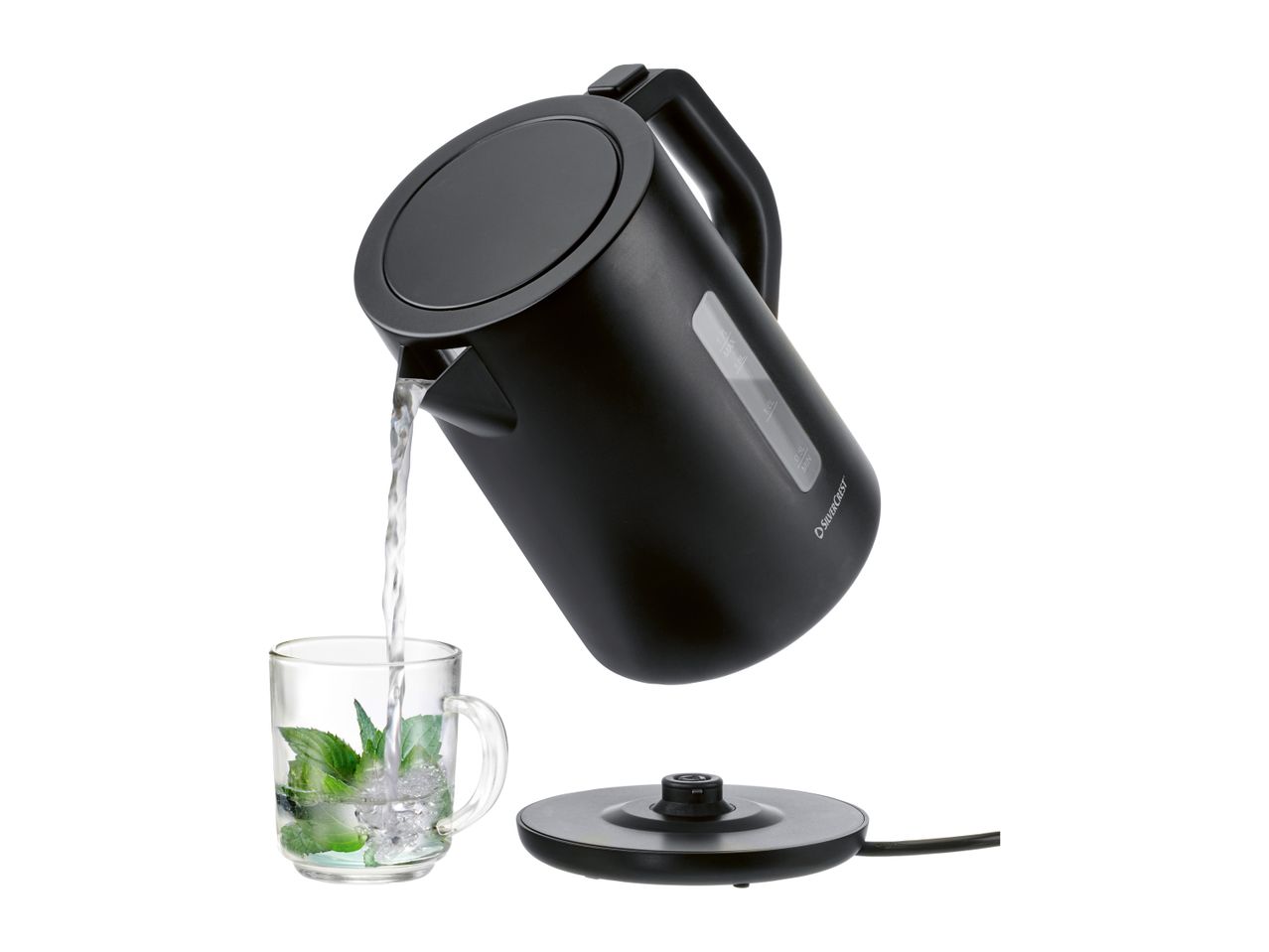 A black stainless steel electric kettle pours water into a glass.