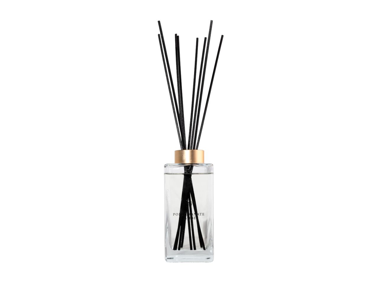 Reed diffuser with black sticks in a glass bottle with a gold cap