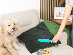 Removing dog hair from a couch with a Petsafe hair remover.