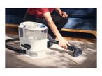A person using a portable carpet cleaner on a grey rug.