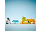 Toy figures of penguins and lions with building blocks on a blue background.