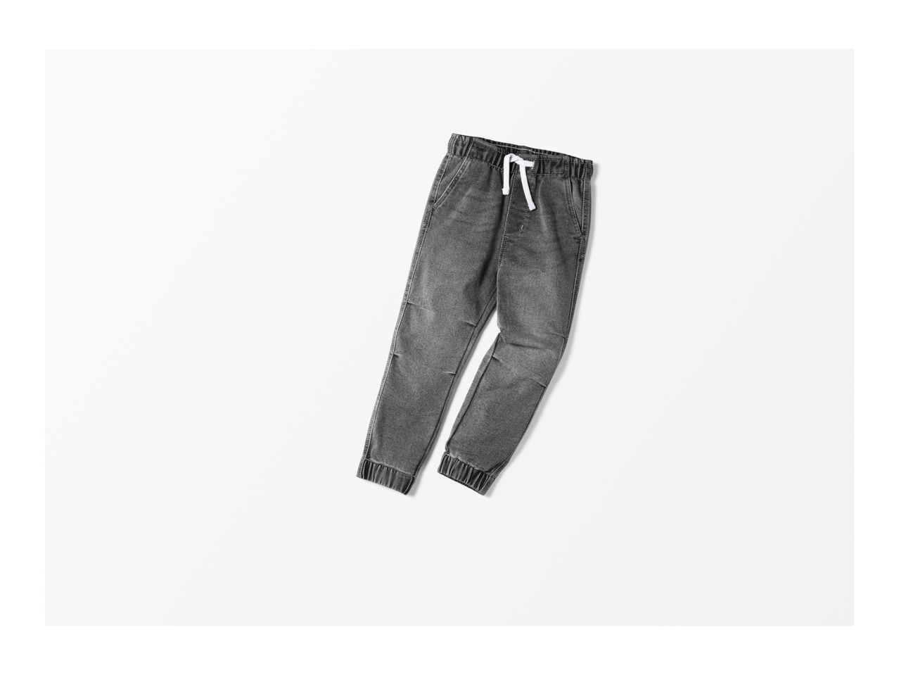 A pair of gray denim jogger pants with a white drawstring on a white background.