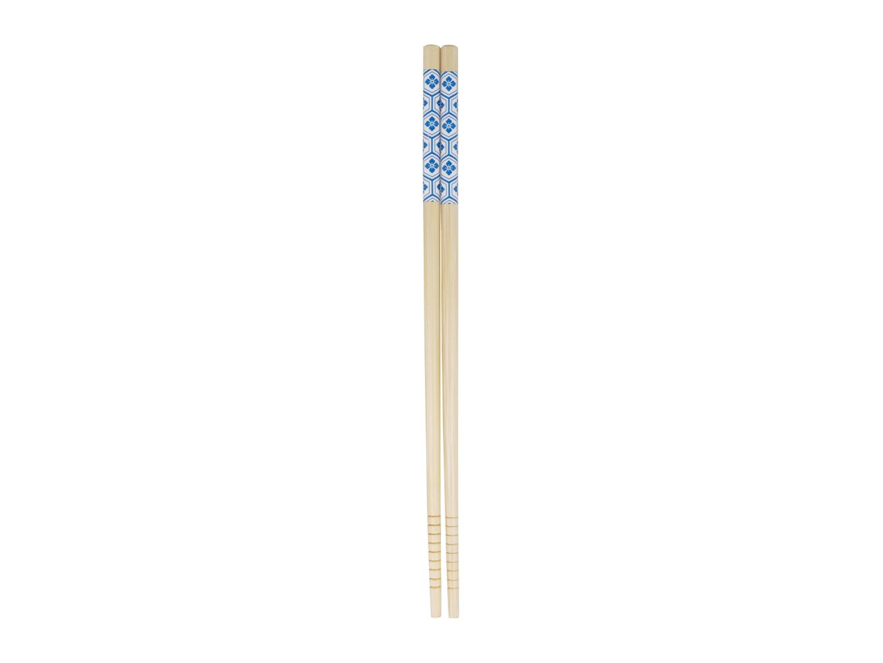 A pair of light-colored wooden chopsticks with a blue decorative band near the top.