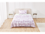 Bedroom with purple floral bedding and white nightstands.