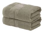 Two folded beige towels with a subtle leaf pattern.