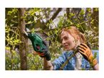 Woman pruning a tree with electric pruning shears, wearing gardening gloves.