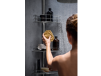Woman in shower reaching for a natural sponge on a LIVARNO home Extendable Bathroom Caddy.