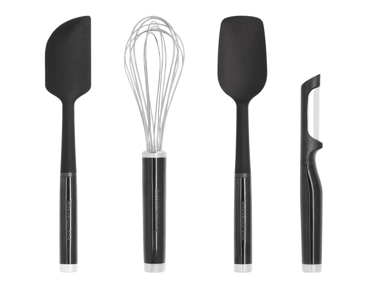 Vier schwarze Küchenhelfer: zwei Spatel, ein Schneebesen und ein Sparschäler.