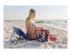 Woman in bikini on beach, sitting next to a blue beach chair and a floral cooler bag.