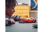 A child plays with a LEGO Ferrari Formula 1 car.