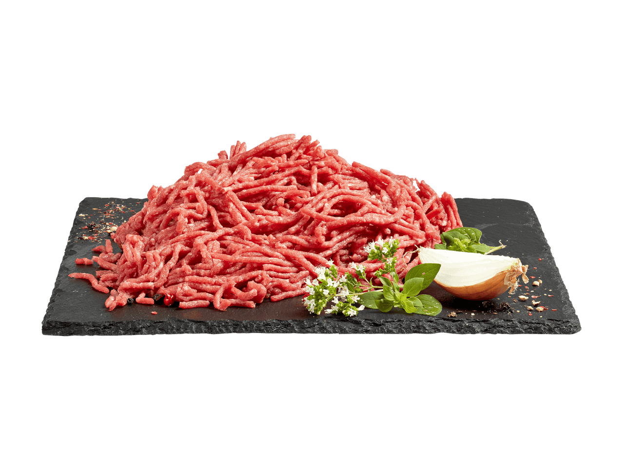 Carne macinata fresca su un tagliere di ardesia con cipolla, erbe e spezie.