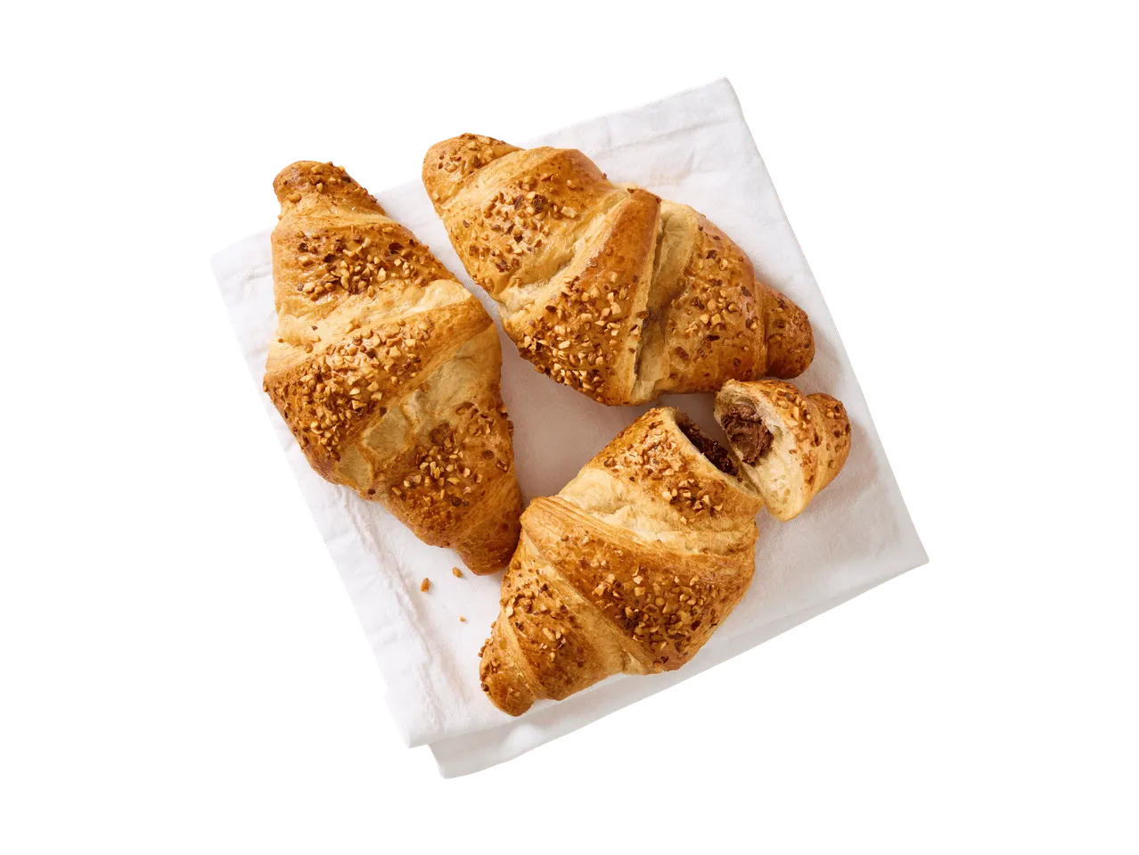 Drei Nuss-Croissants auf einem weißen Tuch, eines davon mit Schokoladenfüllung.