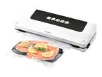 A white and black FoodSaver vacuum sealer with salmon fillets in a vacuum bag.