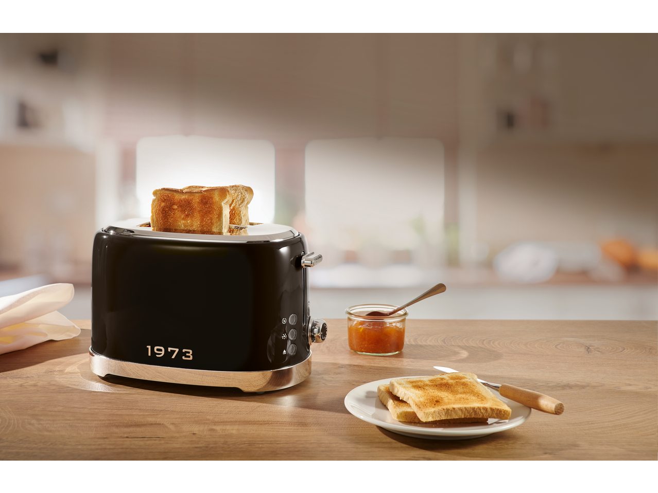 SILVERCREST® 2-Slice Toaster in black with toast and jam on a wooden counter.
