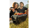 Outdoor grilling with vegetable and meat skewers.