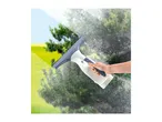 Hand holding a window vacuum cleaner, cleaning a window with a clear view of nature.