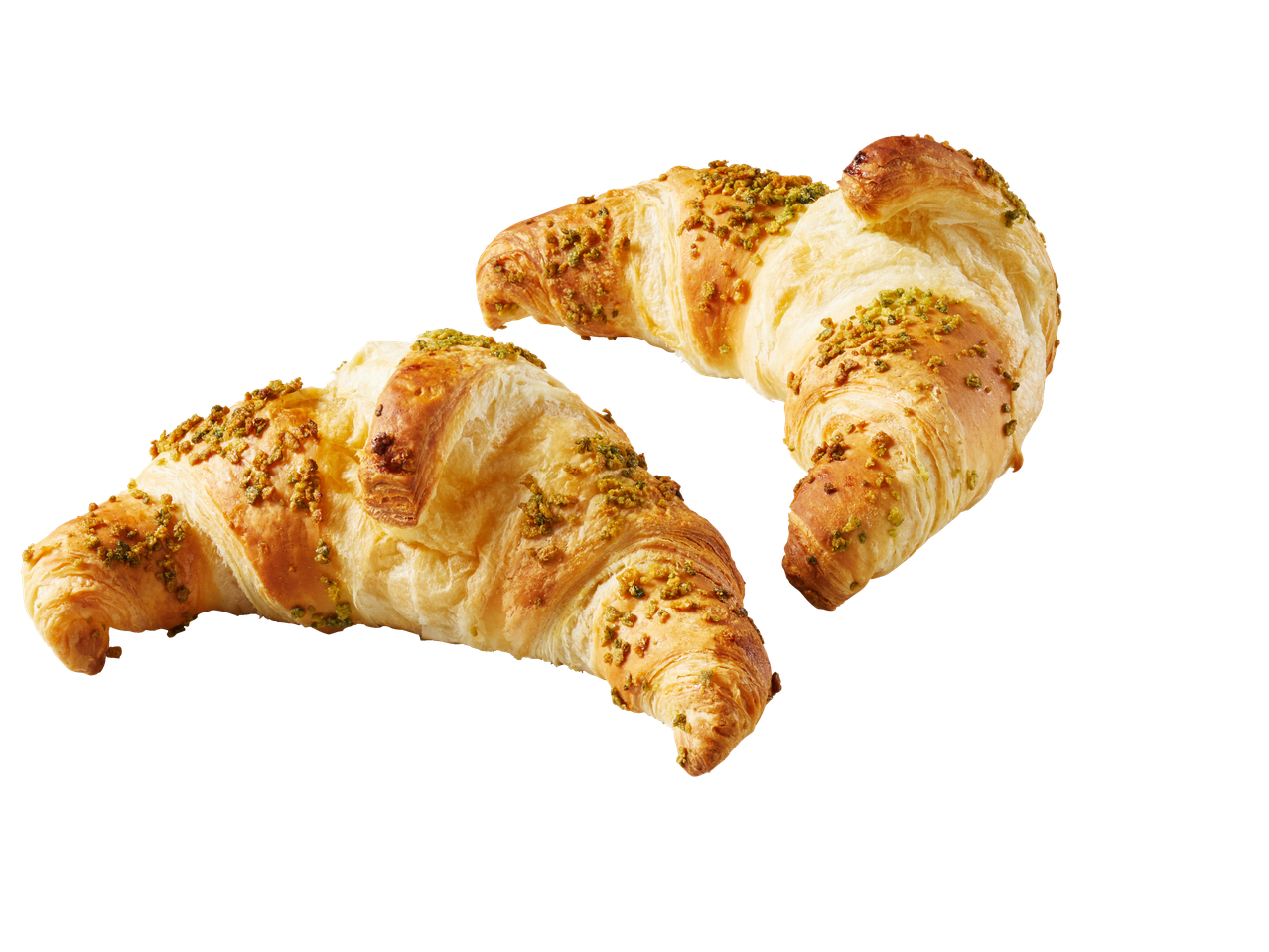 Kaks kuldset, lehtjat pistaatsiakroissantti mustal taustal.